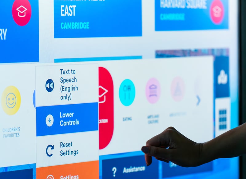 Employee engaging with a large touchscreen at work.