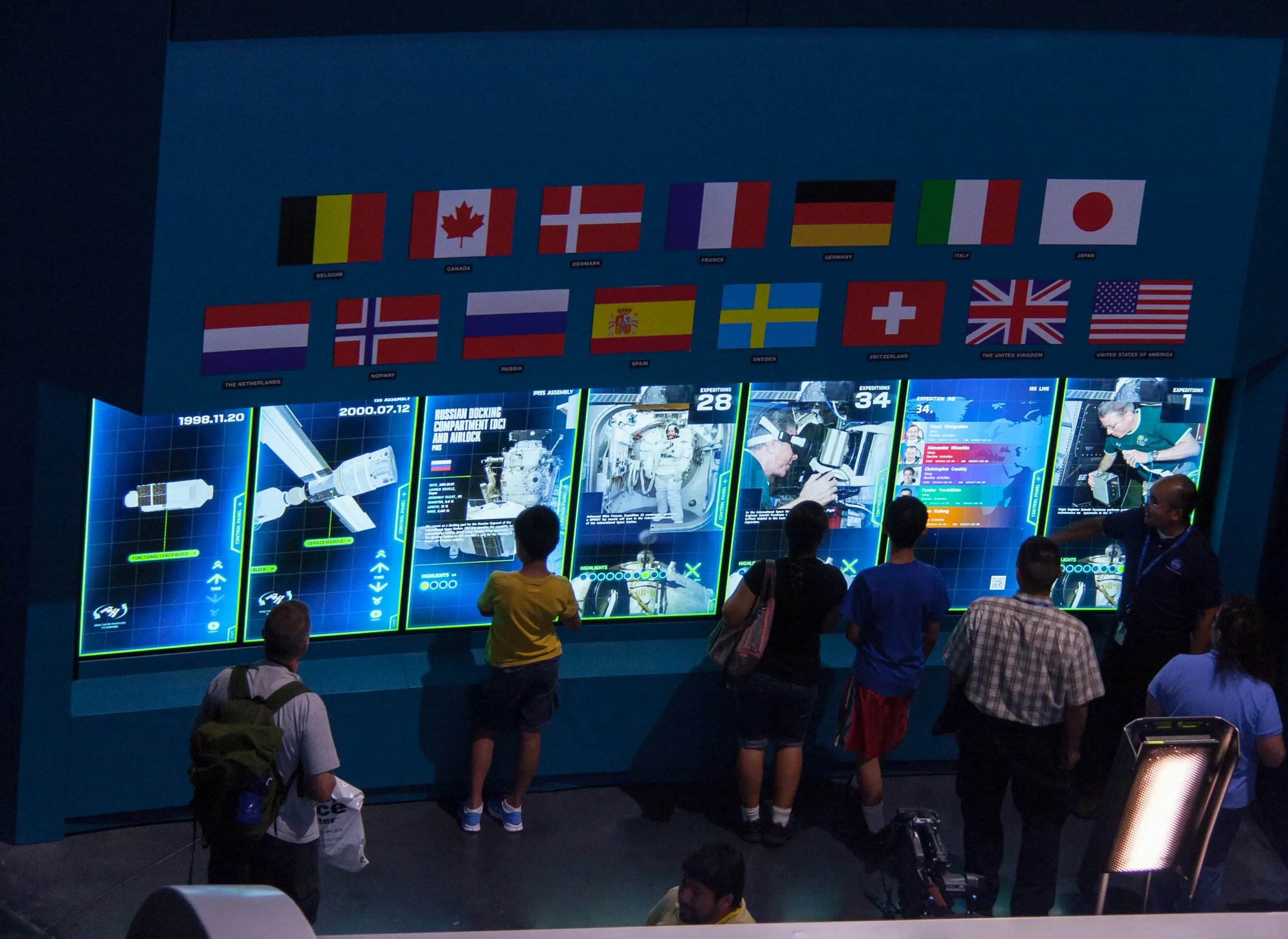 A museum exhibit blends interactive touchscreens with ambient lighting and audio to create an engaging educational experience.
