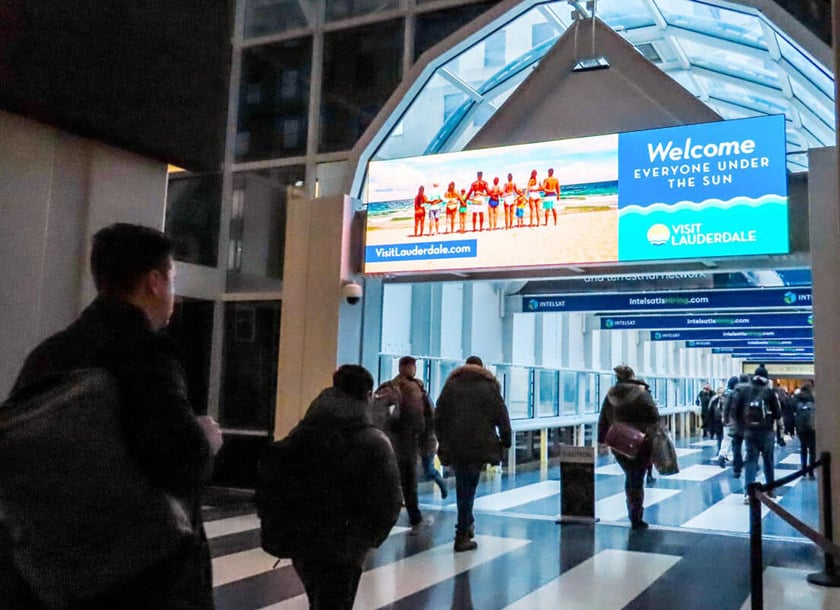Commuters walking underneath a digital billboard at 500 West Madison in Chicago.