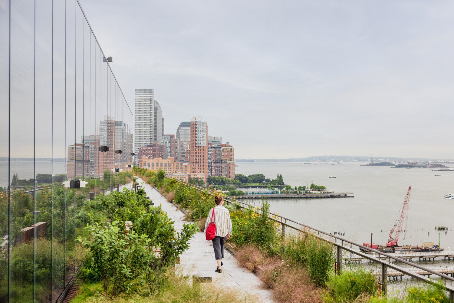 A woman walking on the side of the Google building