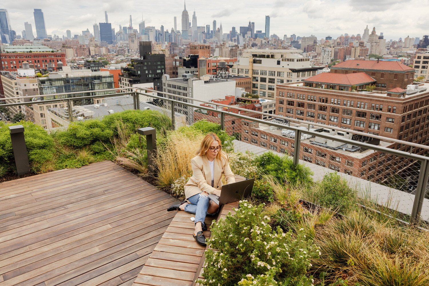 A woman on the terrace working on her computer 