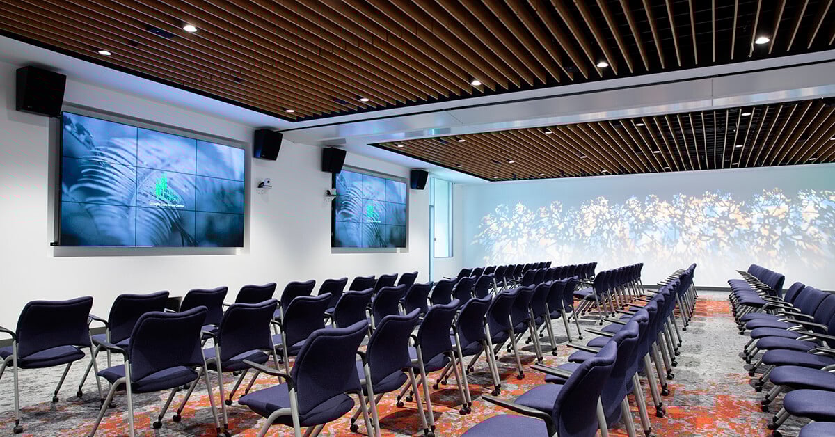 A briefing room with two large LED walls and a projection mapped backwall at the Google Grove Experience Center.