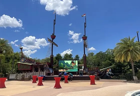 A colorful LED display transforms a themed pirate ship into a storybook scene for children visiting the Give Kids the World Village.