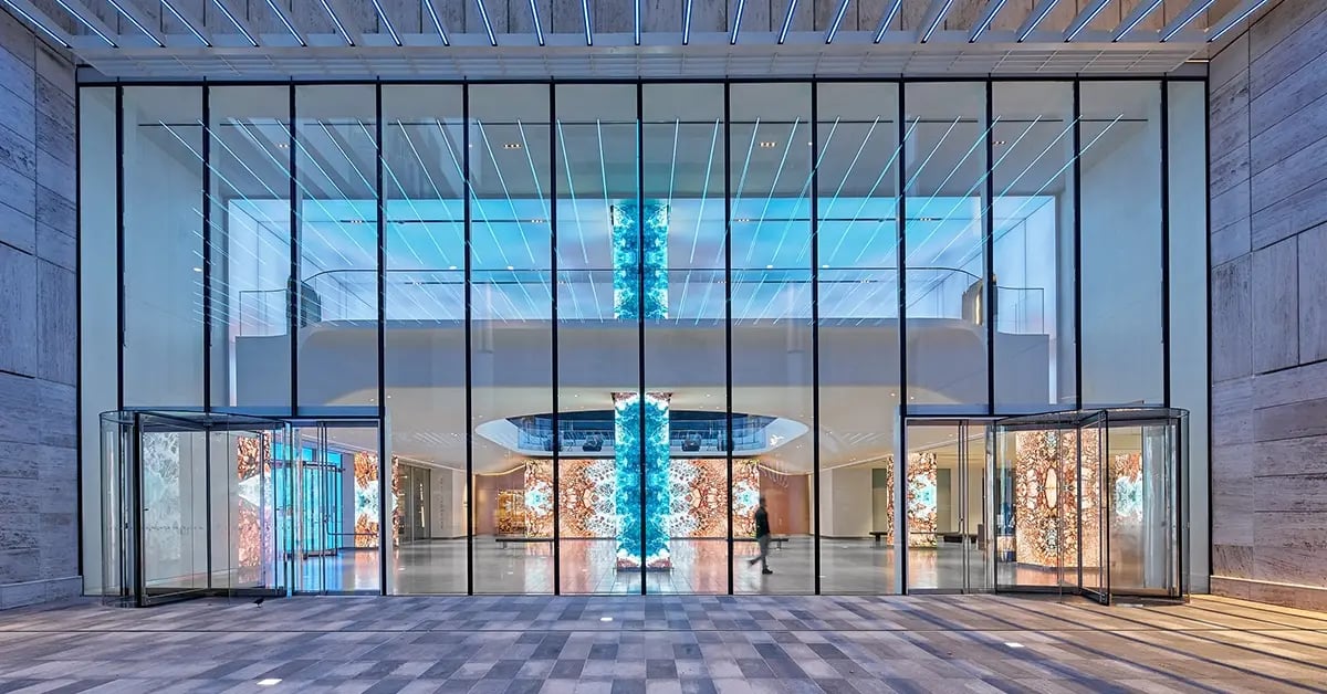 A corporate lobby at AT&T headquarters features a sleek LED video wall displaying real-time data and brand messaging in a polished, high-tech setting.