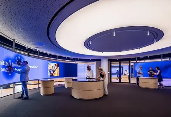 A curved, interactive LED wall welcomes visitors to Zoom’s London Experience Center, offering hands-on engagement with the company’s collaboration tools.