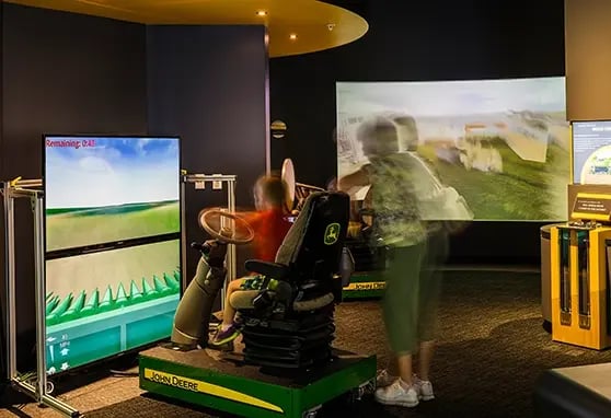 A grandmother and her grandson playing a farming simulation game at the Farm Wisconsin Discovery Center.