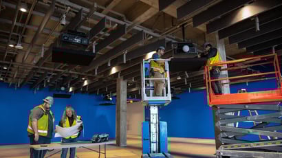 A group of AV technicians installing projectors at a customer site.