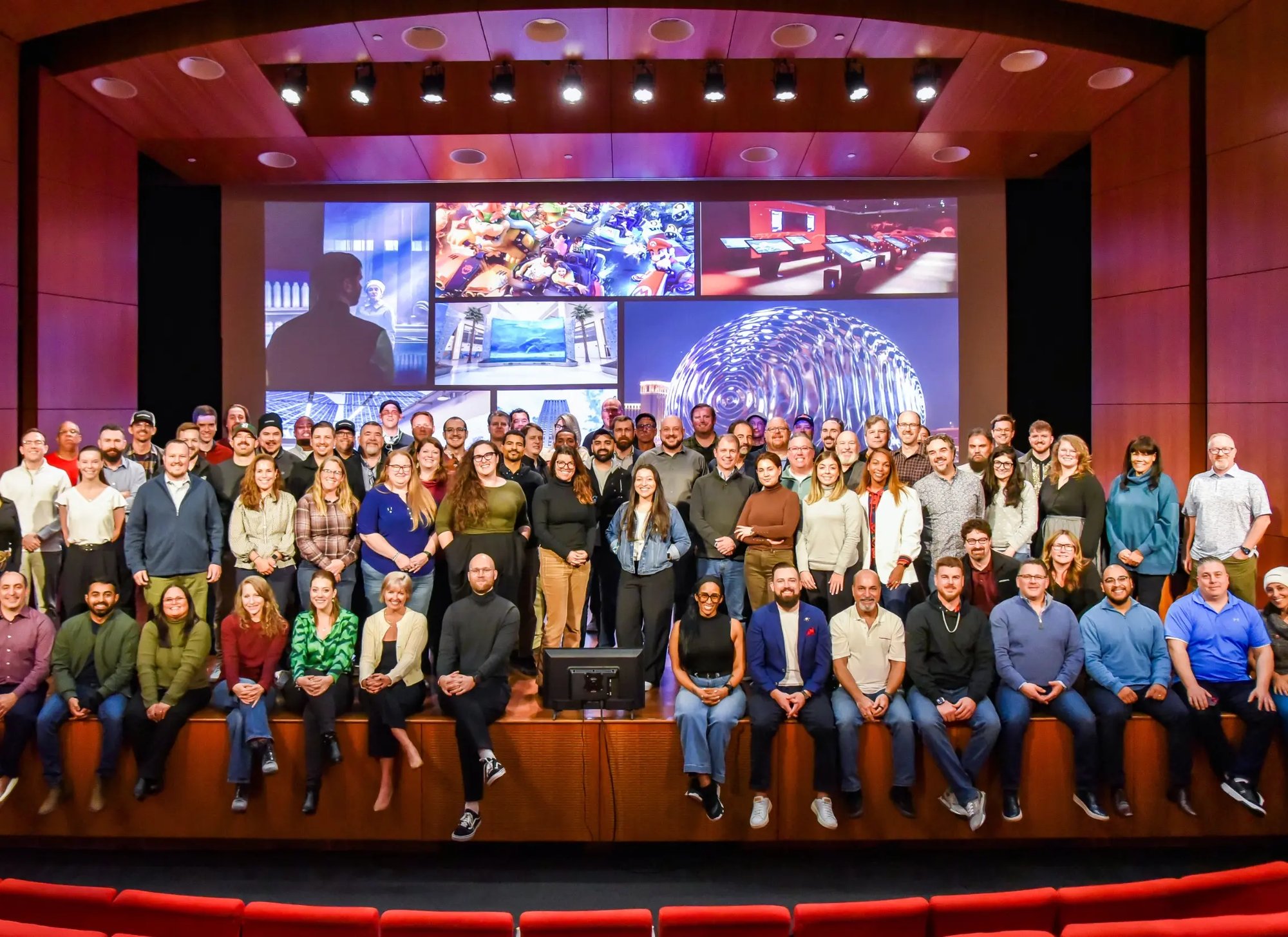 A group of Electrosonic employees seated for a group photo during an event in Kansas City, MO.