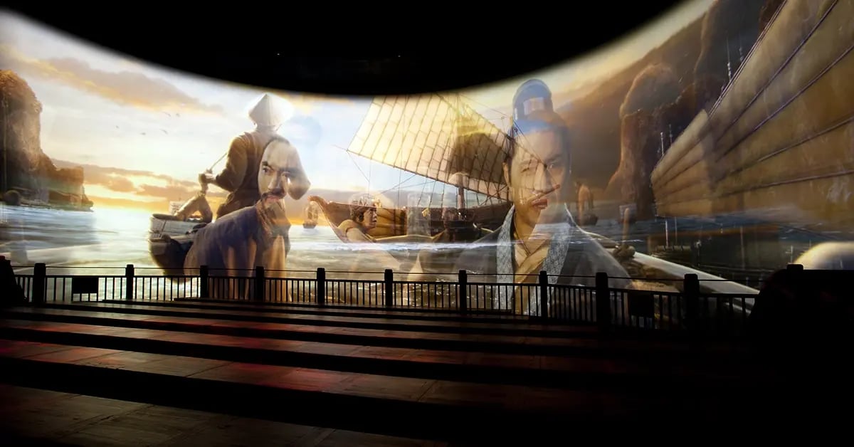 A large curved projection screen fills the theater, displaying vivid, immersive content that transforms the space.