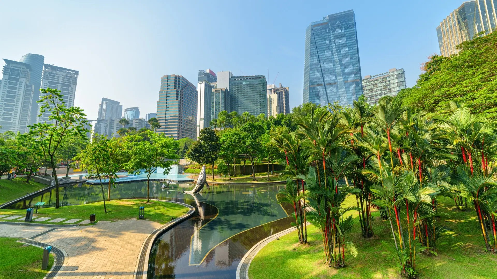 A modern city enveloped in green spaces.