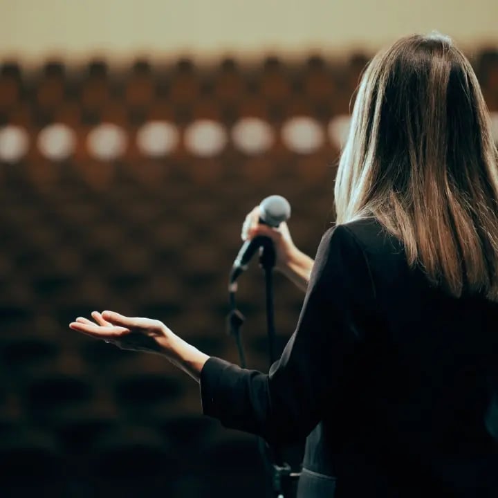 A presenter for an event completing a technical rehearsal.