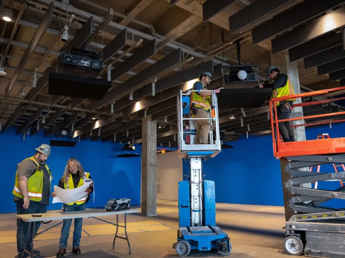 A team of Electrosonic employees performs on-site maintenance on AV systems.