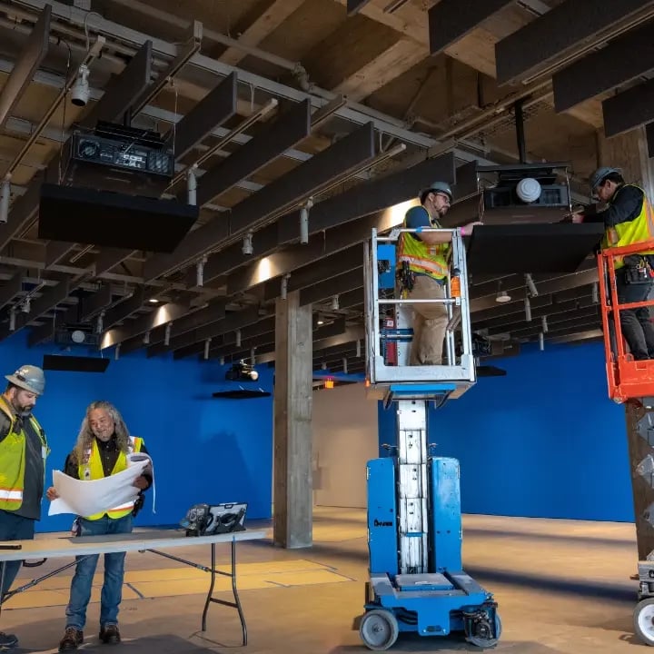 A team of Electrosonic employees works onsite to complete an AV system upgrade efficiently.