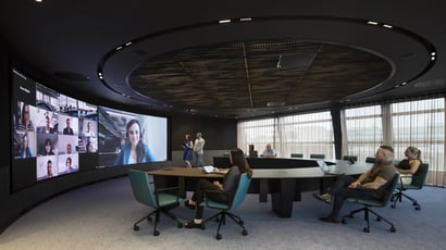 A technology assessment review meeting with Electrosonic, discussing AV system performance and recommendations.