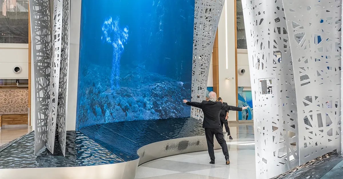 A traveler to the Orlando International Airport interacting with large video walls prior to his flight.