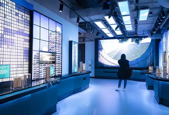 A visitor looking at a high-impact video wall showing immersive views of Chicago’s architecture.