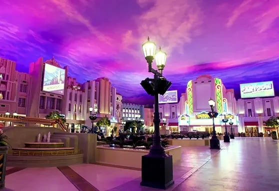 A wideangle photo of the Cinema Spectacle at Warner Bros. World Abu Dhabi. Showing off the largest interior projection mapped experience in the world.