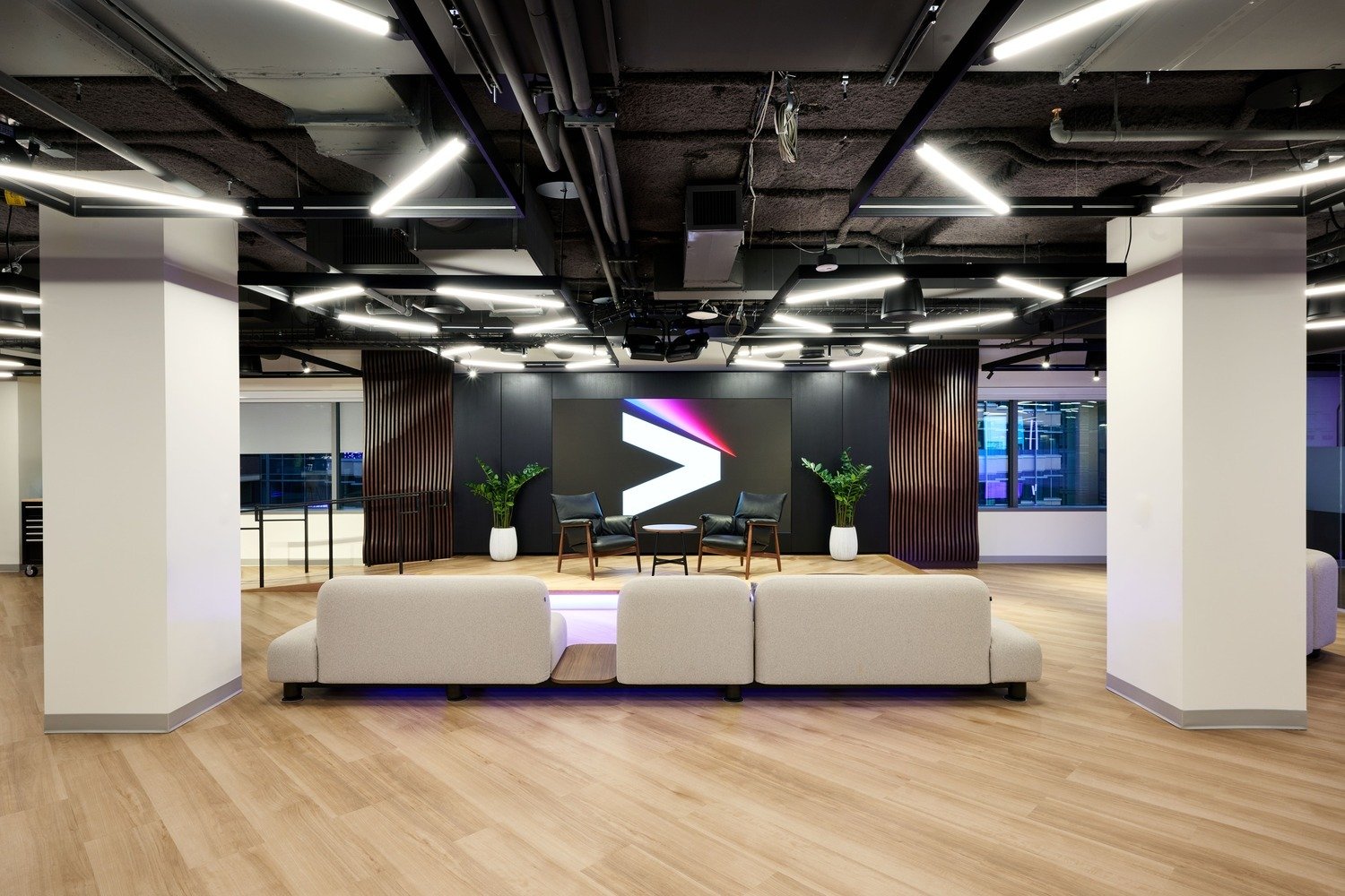 A behind angle of the meeting room where the LED wall is front and center. 