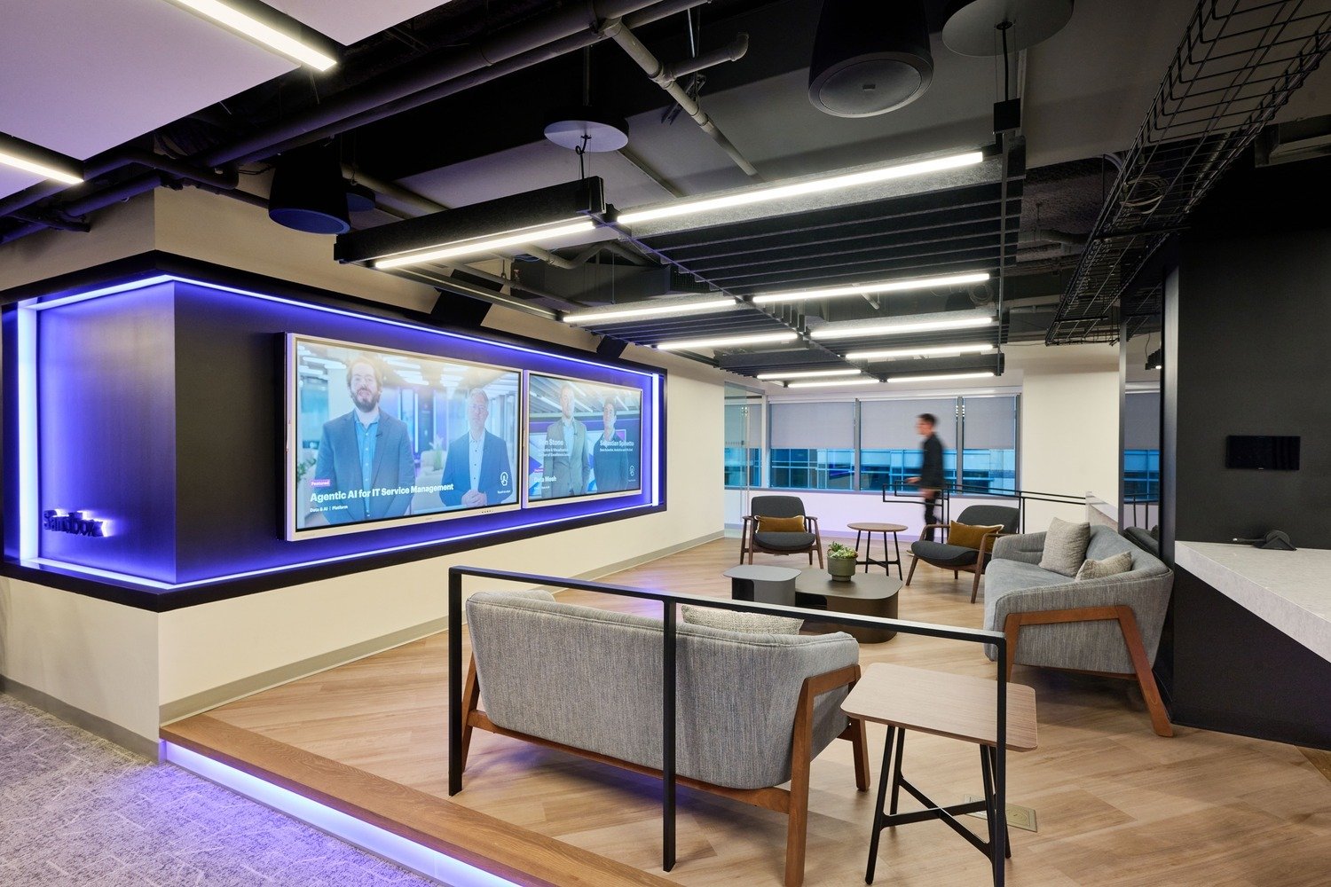 A sitting area with chairs and an interactive LED wall.