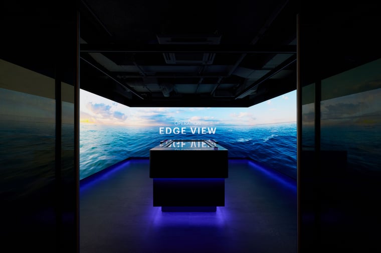 Interactive touch table with media walls displaying 