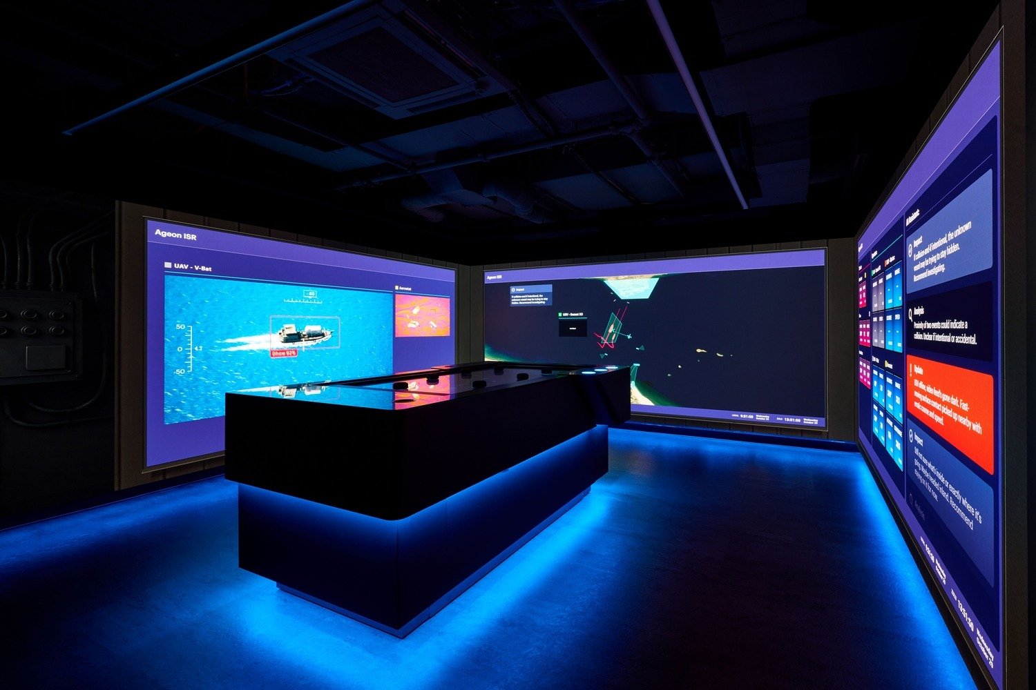 A meeting room with three LED walls and a interactive touch table. 