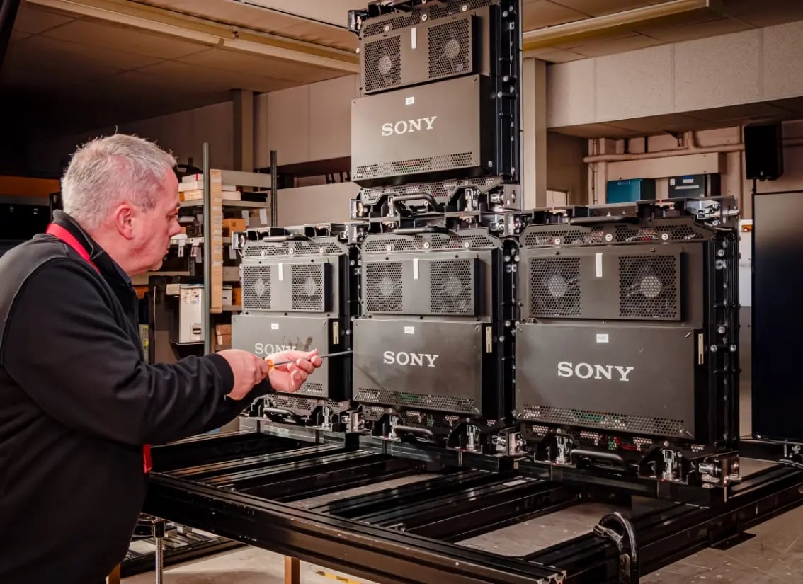 An Electrosonic AV technician configuring a equipment during the fabrication phase of an AV systems construction