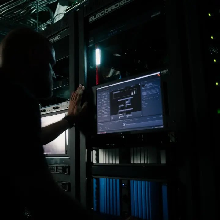 An Electrosonic AV technician loading programs and firmware into an Electrosonic built system.