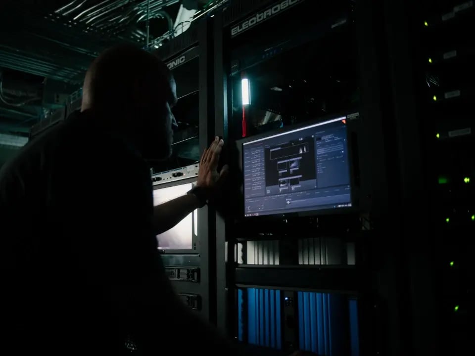 An Electrosonic AV technician testing and commissioning equipment before pushing it live.