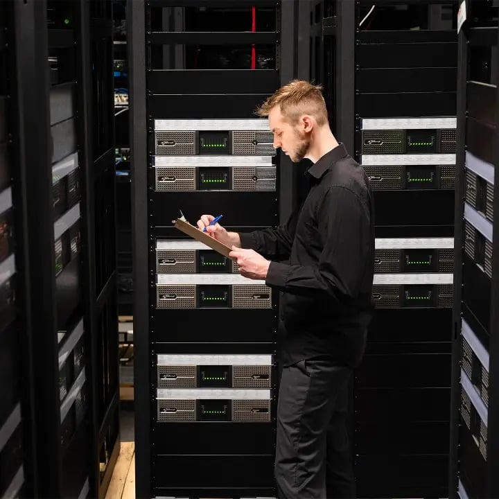 An Electrosonic employee completing quality control reporting of AV racks before theyre shipped to a customer site.