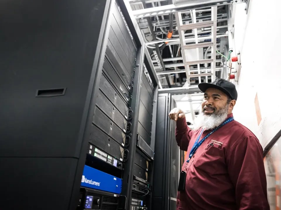 An Electrosonic employee inspects AV equipment onsite to ensure proper performance and reliability.