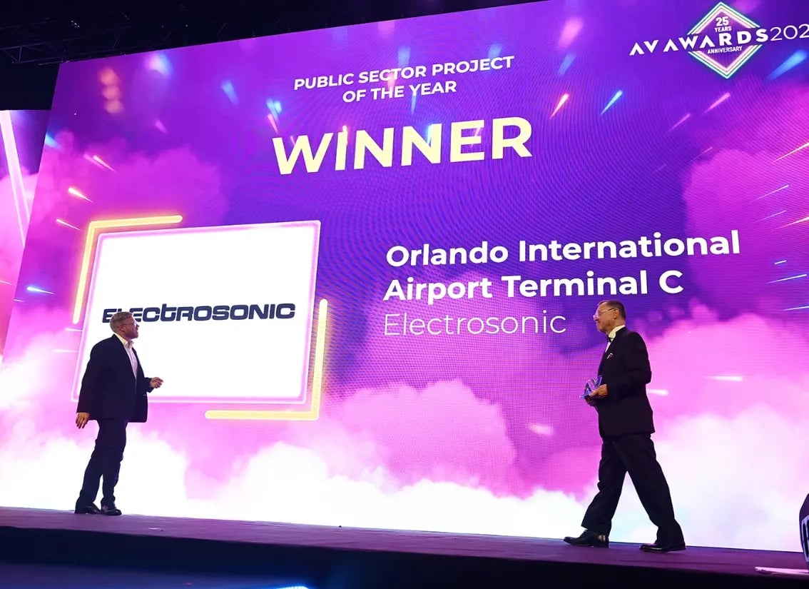 An Electrosonic representative collecting an award during the AV Awards ceremony.