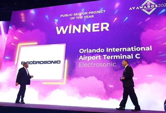 An Electrosonic representative collecting an award during the AV Awards ceremony