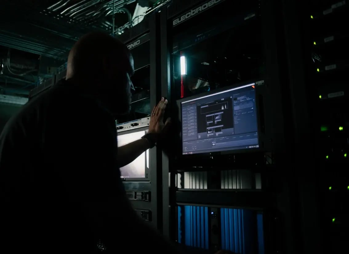 An Electrosonic technician testing a system from the rack room to ensure the system is working correctly.