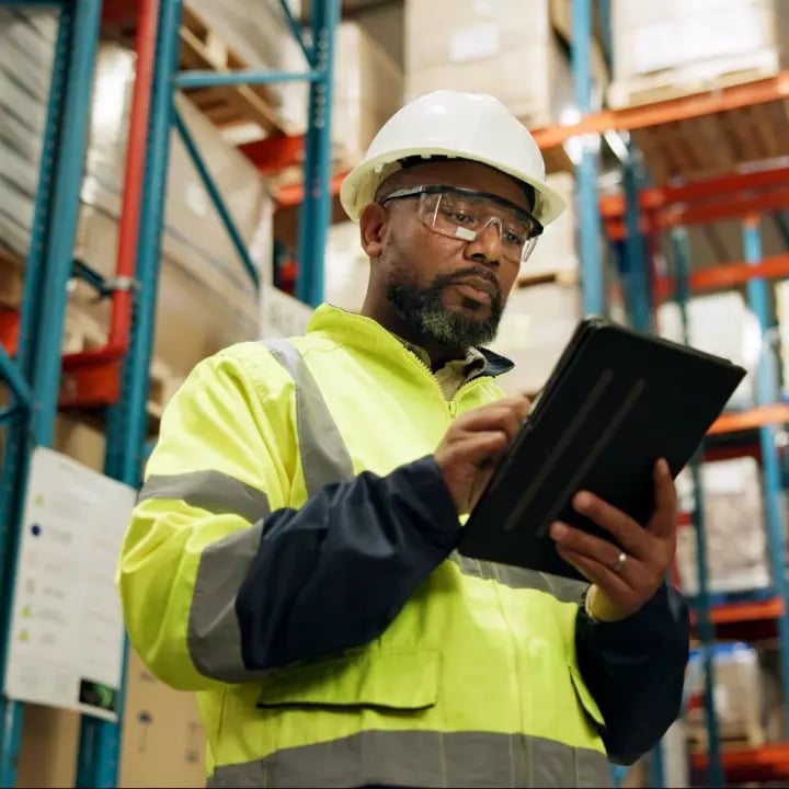 An Electrosonic warehouse employee checking on the delivery status of AV equipment.