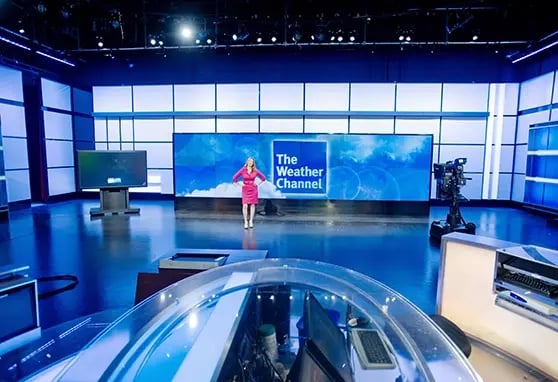 An LED backdrop in The Weather Channel’s studio displays real-time weather graphics, storm tracking and live updates for broadcast segments.