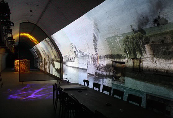 An interior view of the Dover tunnel, showing the operations tables and wartime images on the walls.