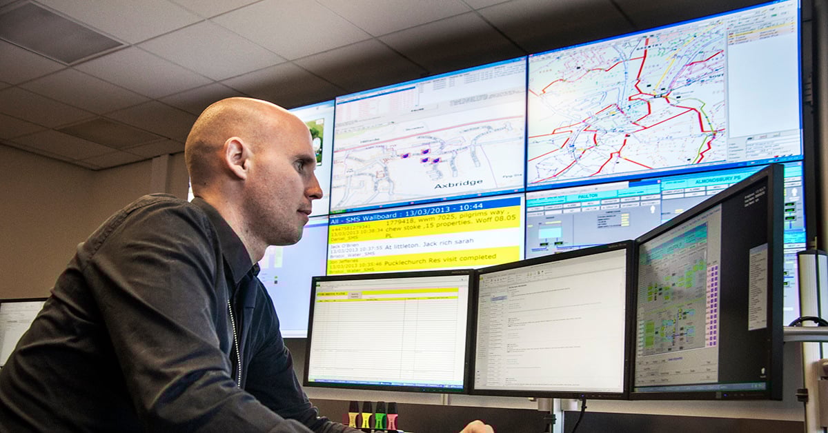 A control room operator monitoring systems at an Electrosonic built control room system.