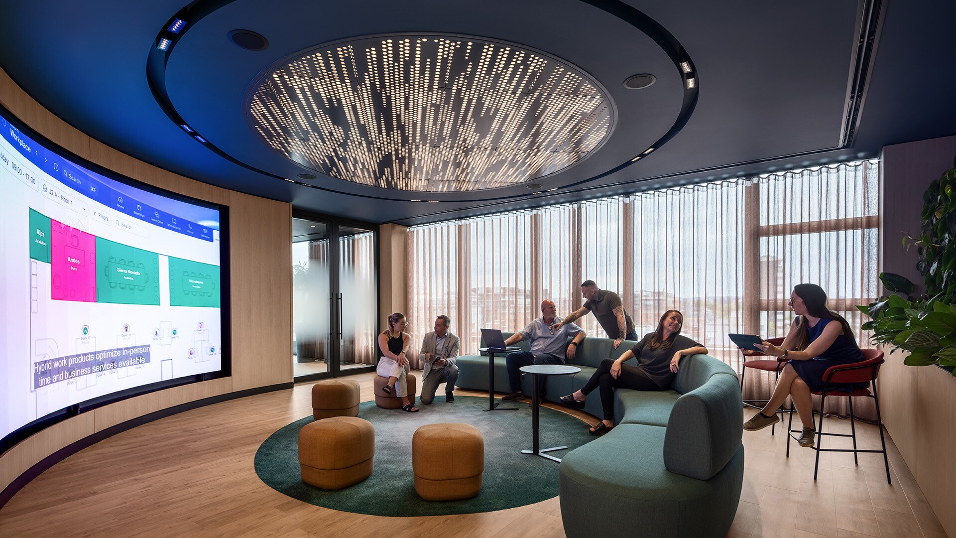 Group of employees in a modern meeting room with the latest meeting room technology.