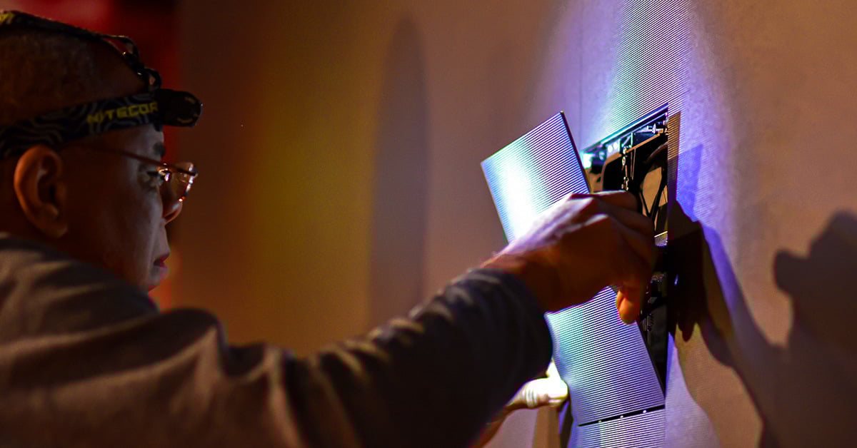 An Electrosonic technician replacing an LED panel. 