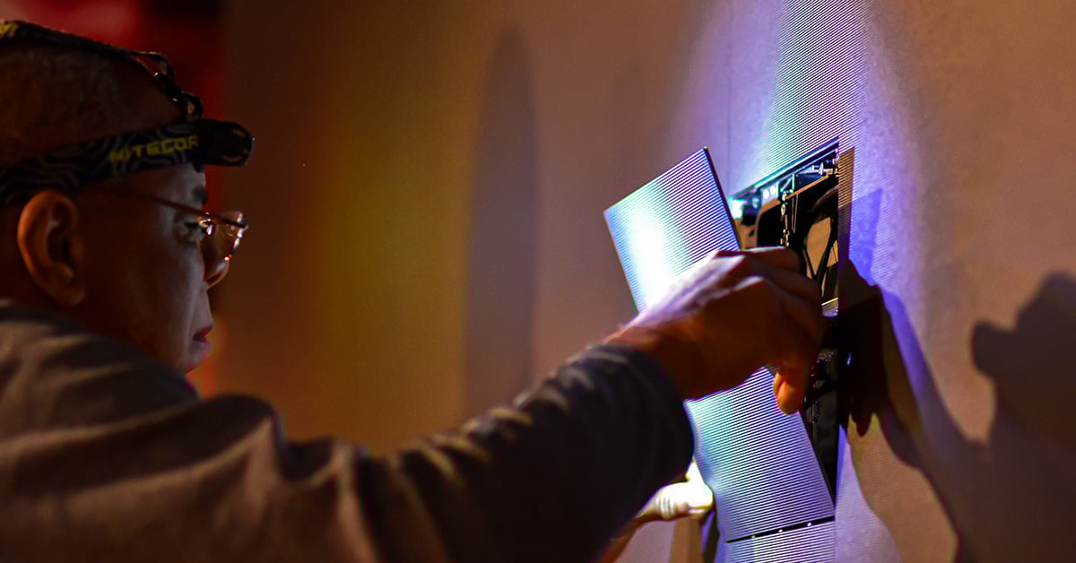 Electrosonic technician replacing an LED panel.