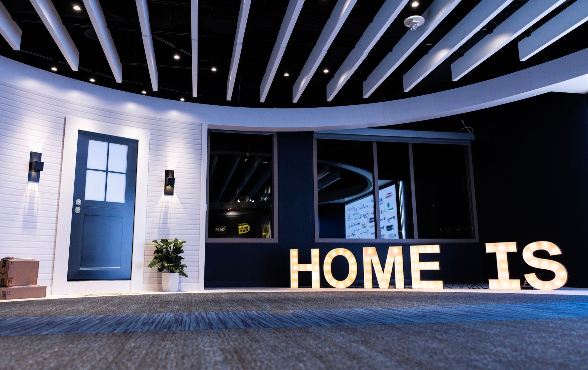 Lobby with an interactive door and a home digital signage of 'Home is'. 