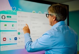 A man touching an interactive screen.