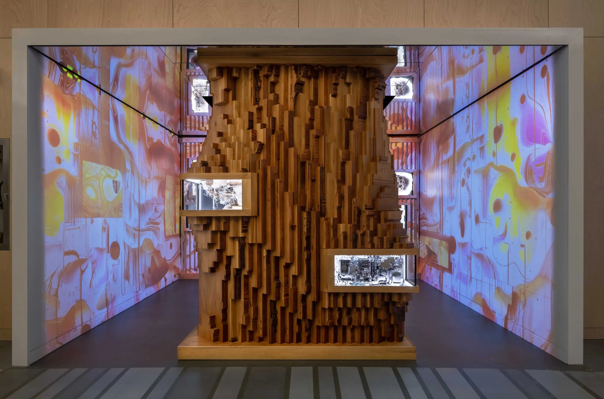 Certain Measures Recombinant Room #03  - a wood structure in the middle of the room with LED surrounding it.