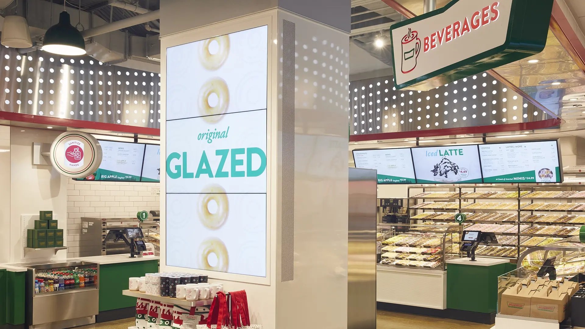 Digital signage and digital menu boards displaying vibrant doughnut images and clear menu options inside Krispy Kreme’s Times Square flagship store