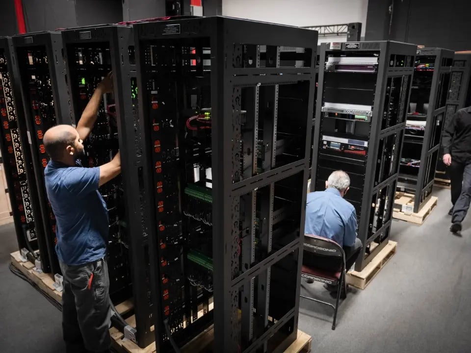 Electrosonic AV technicians building AV racks at an Electrosonic facility.