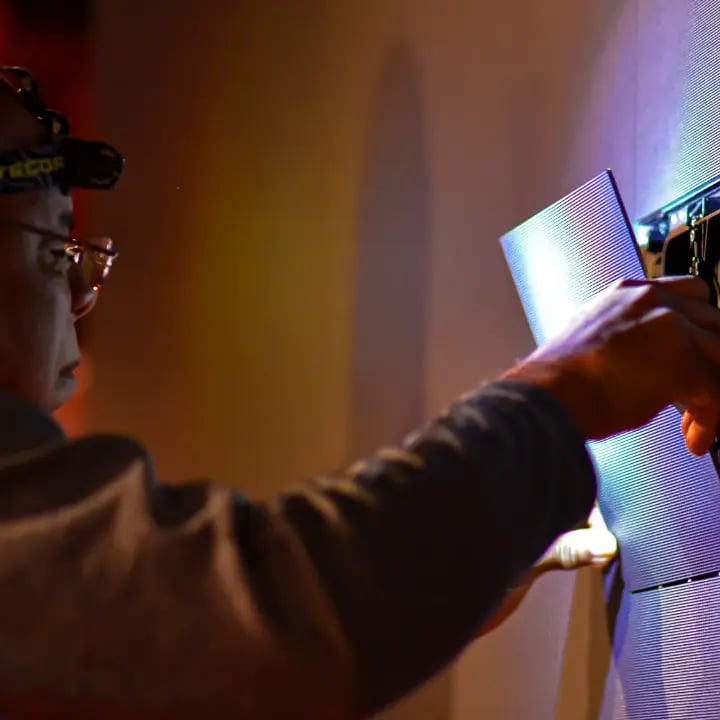 Electrosonic technicians repair and optimize AV equipment during an on-site visit.