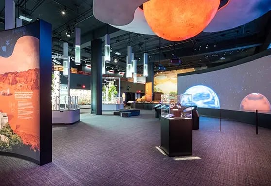 Exhibit space at the Carnegie Science Center, at the center of the exhibit a multi-projector installation allows guests to learn about other planets.