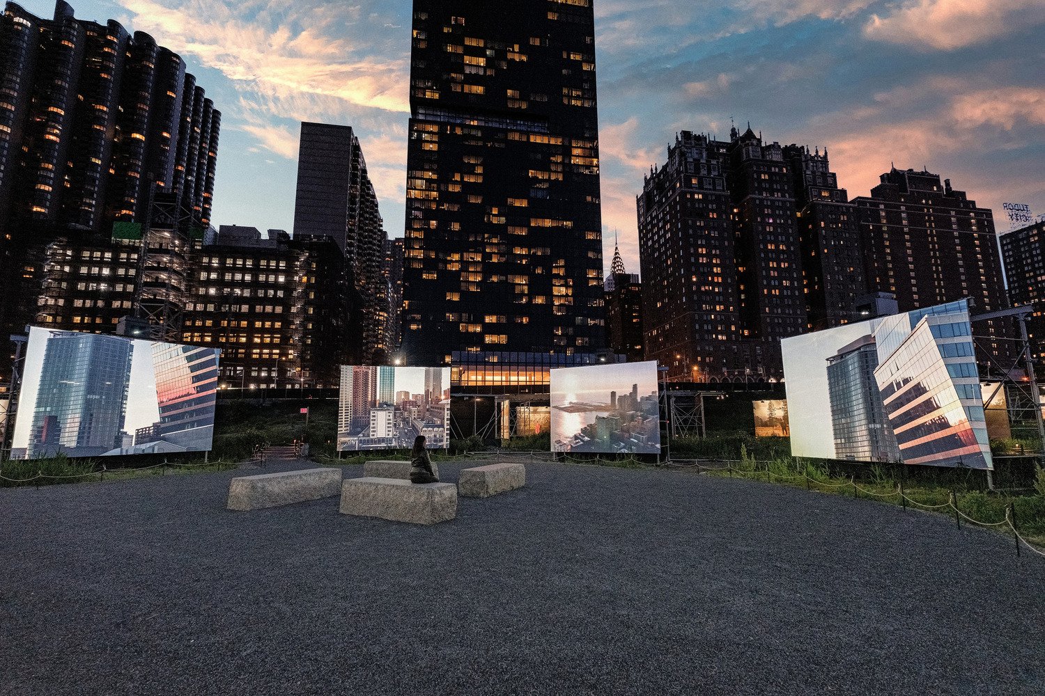 Screen displays showing American landscape with visitors sitting in the middle.