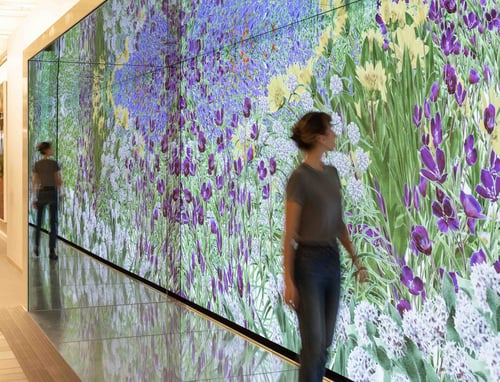 Woman walking in front of LED wall 