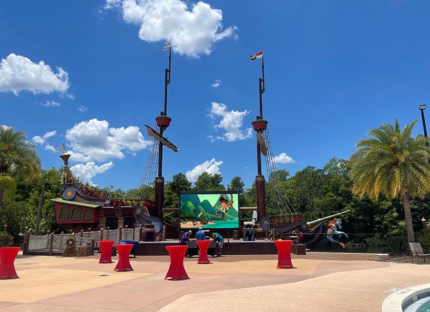 The Pirate Ship ‘Serendipity’ attraction at Give Kids the World Village features a whimsical, brightly colored vessel surrounded by playful scenery and tropical landscaping. Designed for imaginative adventures, the ship invites children to climb aboard and explore a magical, pirate-themed world.